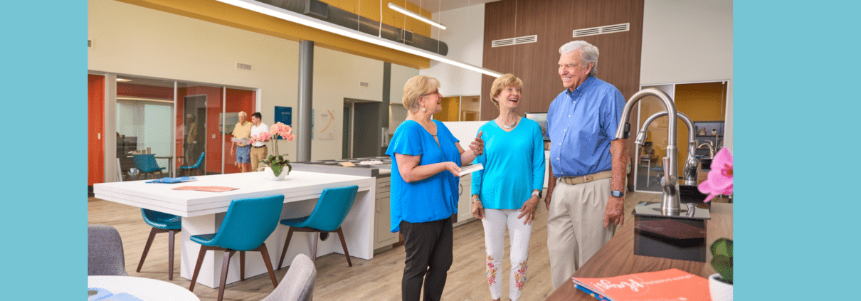 Move-In Manager Phyllis discusses design options with two residents, Jackie and Dave while standing in the Design Center