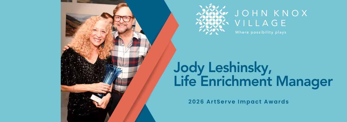 Jody Leshinsky holding an ArtServe award