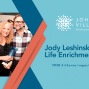 Jody Leshinsky holding an ArtServe award