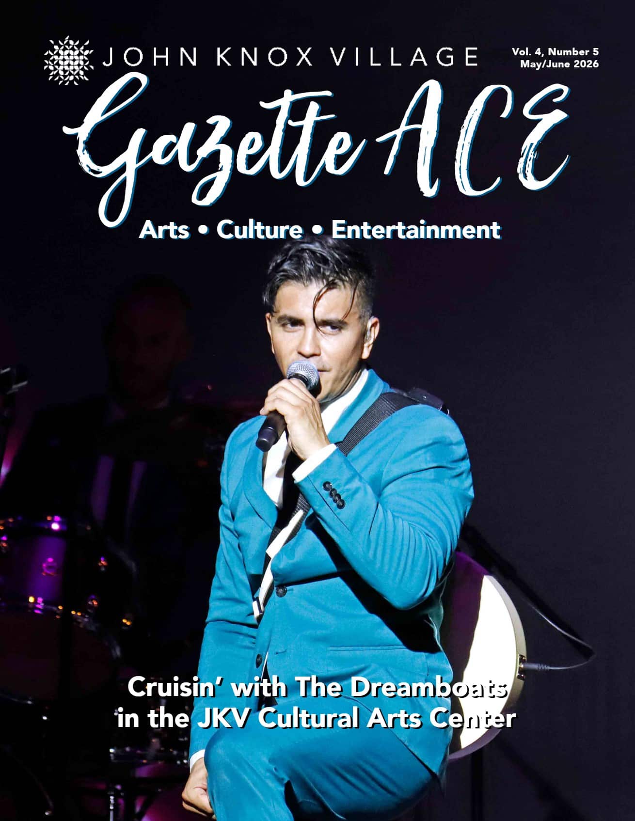 Lead singer of the band, the Dreamboats on one knee singing into a microphone