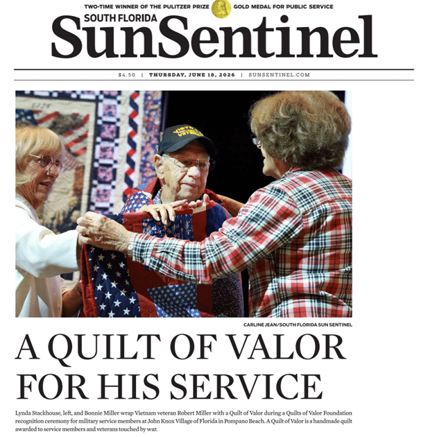 Sun Sentinel news clipping JKV resident veteran Bob Miller being draped with patriotic quilt